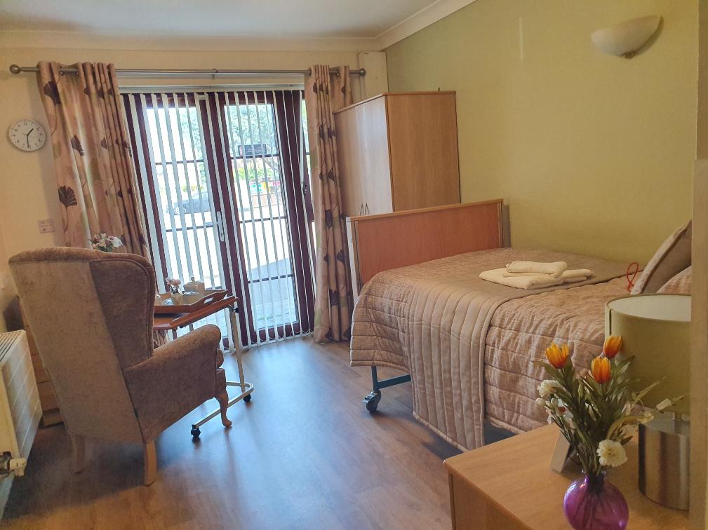 a bedroom with an armchair